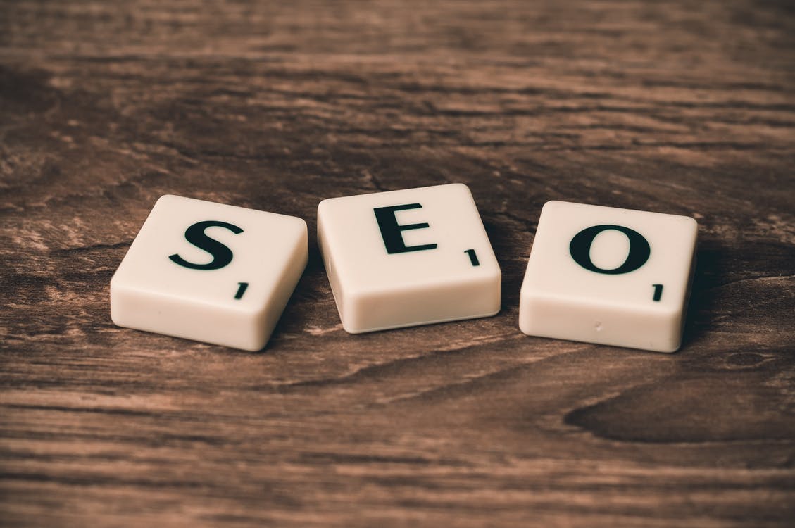 SEO Scrabble letters on a wooden table.