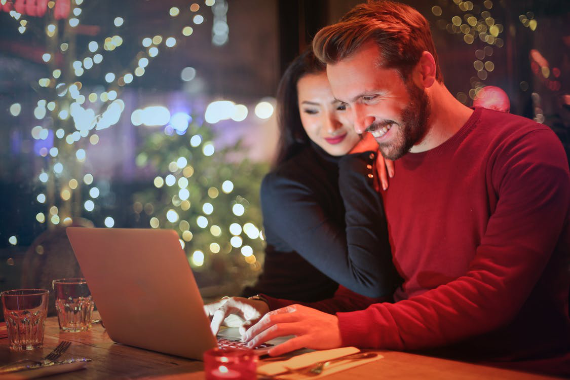 A happy couple doing holiday shopping on an optimized website