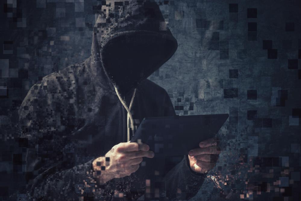 Pixelated unrecognizable faceless hooded cybercriminal.